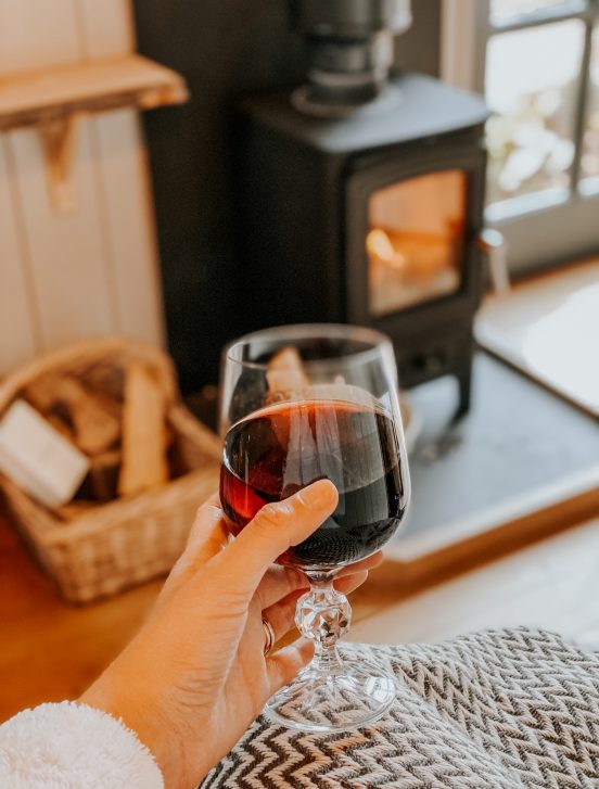 Wine Glass In front Of Log Fire